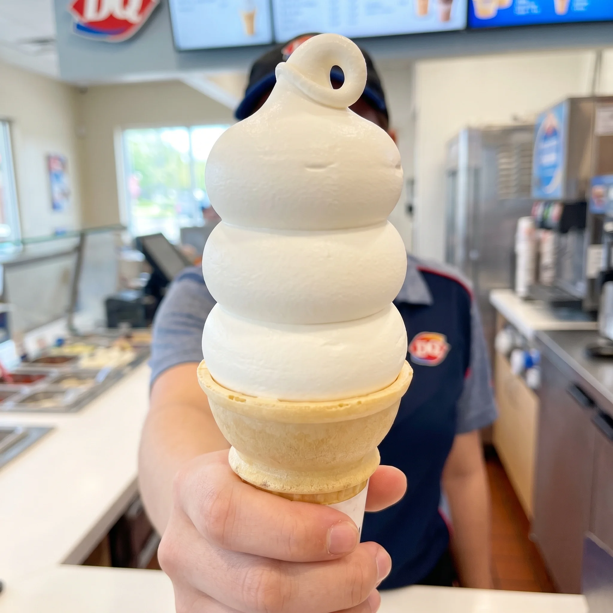 Dairy Queen classic vanilla soft serve cone with signature DQ curl served over the counter
